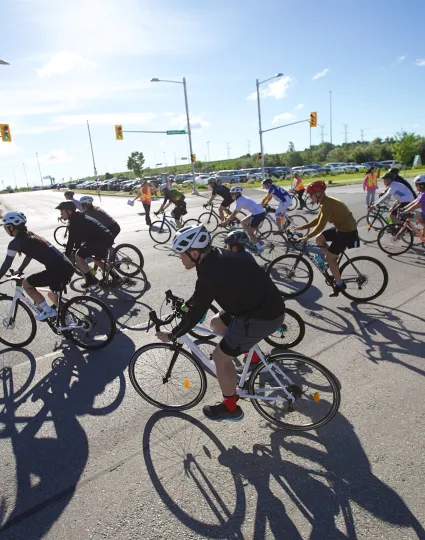 Large group of cyclists making a turn.