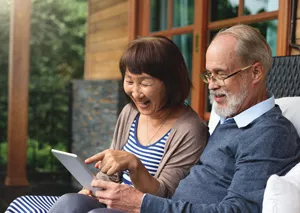 Older adult couple looking at an iPad