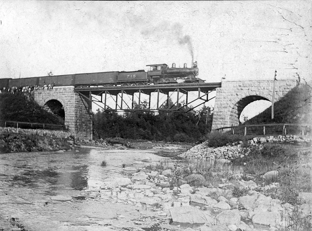 train going over historical bridge