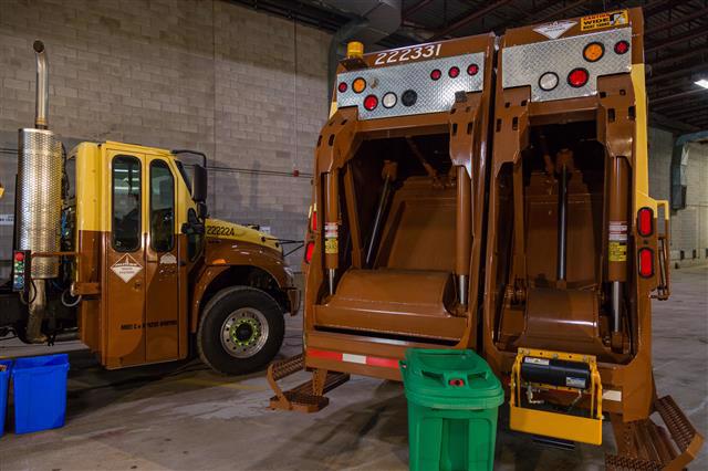 Green bin organics and clear bag garbage are now collected in rear-load trucks.